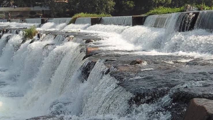 A wide waterfall cascading over dark rock in the founder's home village